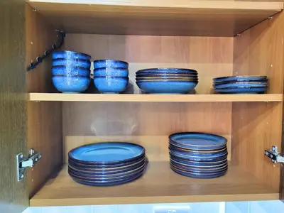 a bunch of blue bowls are sitting on a shelf at Sunshine Escape in Larnaka