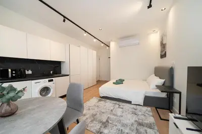 a bedroom with a bed and a table and chairs at Luxury Studio in the Heart of Limassol in Limassol