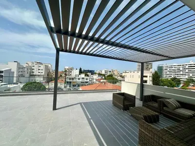 awning on top of a roof with a view of a city at Luxury Studio in the Heart of Limassol in Limassol