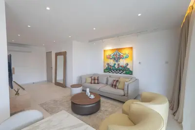 a living room with a couch and a table at Mackenzy Dream Residence 202 in Larnaka