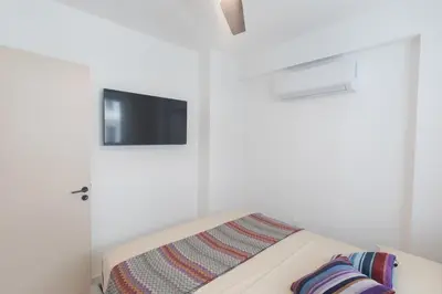 a bedroom with a bed with a tv on the wall at Mackenzy Dream Residence 202 in Larnaka