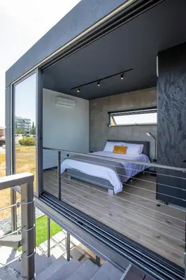 a bedroom with a bed on a wooden deck at Mi Filoxenia 1 in Aglantzia