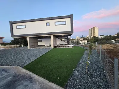 a house with a green lawn in front of it at Mi Filoxenia 1 in Aglantzia
