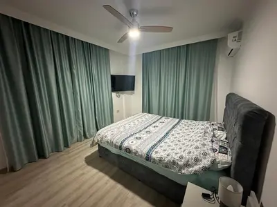 a bedroom with a bed and a ceiling fan at Park Residence Premium in Larnaka