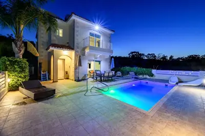 a villa with a swimming pool at night at Protaras Holiday Villa - Katia 8B in Protaras