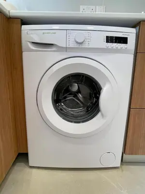 a white washing machine sitting in a kitchen at Downtown Larnaca Apartment in Larnaka