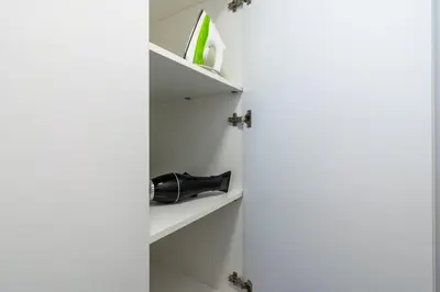 a wine bottle on a shelf in a room at Tangerine Modern 1-BR Apartment in Larnaca in Larnaka