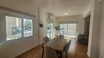 a dining room with a wooden table and chairs at STAY Hydra Comfort Apartment in Nicosia