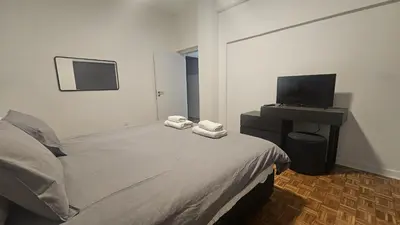 a bedroom with a bed and a flat screen tv at STAY Hydra Comfort Apartment in Nicosia