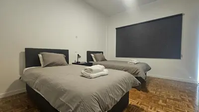 two beds in a room with a large screen at STAY Hydra Comfort Apartment in Nicosia