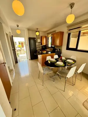 a kitchen and dining room with a table and chairs at Villa ILIOS Cozy 2BR with Pool in Paralimni