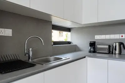 a kitchen with a sink and a counter top at Solara - Stylish Balcony Apartments in Larnaca in Larnaka