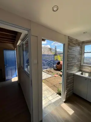 a kitchen with a sliding glass door leading to a yard at Odou Residence in Odhou