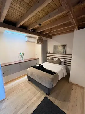 a bedroom with a large bed and a large window at Odou Residence in Odhou