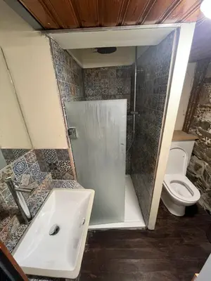 a bathroom with a shower and a sink and a toilet at Odou Residence in Odhou