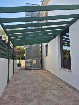 awning on the side of a building with a patio at Konnos Studio in Protaras