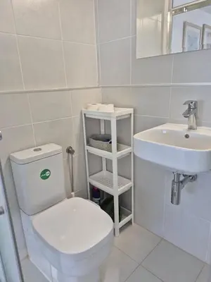 a bathroom with a white toilet and a sink at Konnos Studio in Protaras