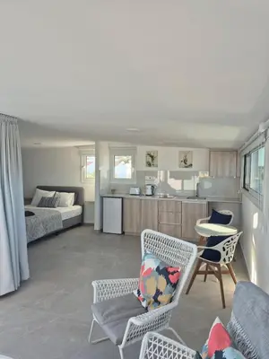 a living room with a bed and a table and chairs at Konnos Studio in Protaras