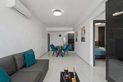 a living room with a couch and a table at Modern 2BR Apartment Near Ayia Napa - Anastasia 101 in Xylophaghou