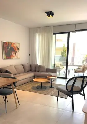 a living room with a couch and tables at 201 Lux Suite Tower206 in Lakatamia