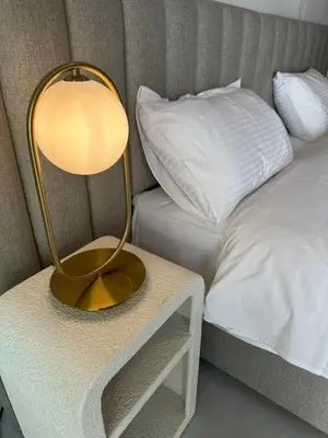 a lamp on a table next to a bed at 201 Lux Suite Tower206 in Lakatamia