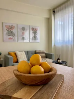 a bowl of oranges on a table in a living room at Cozy apartment in Larnaca City Center in Larnaka