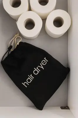 a black and white bag next to white toilets at Cozy apartment in Larnaca City Center in Larnaka