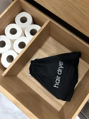 a wooden drawer with a box of rolls of toilet paper at Best location in Larnaca 100m from the beach in Larnaka