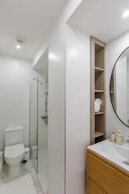 a white bathroom with a shower and a toilet at Best location in Larnaca 100m from the beach in Larnaka