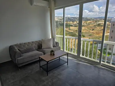 a living room with a couch and a table at Studio by The Sea in Limassol