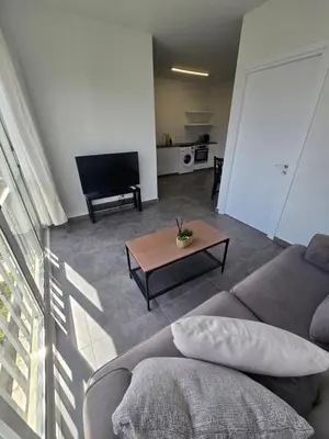 a living room with a couch and a table at Studio by The Sea in Limassol