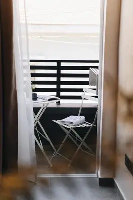 a room with a table and chairs and a window at Kition Urban Suite 3 in Larnaka