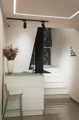 a chair sitting next to a counter with stairs at Kition Urban Suite 3 in Larnaka