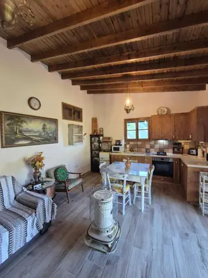 a kitchen and living room with a table and chairs at Cozy Paradise in Pedoulas