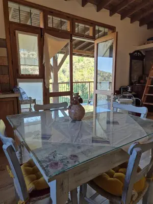 a glass table with a vase sitting on top of it at Cozy Paradise in Pedoulas