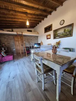 a living room with a wooden table and chairs at Cozy Paradise in Pedoulas
