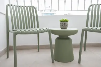 a plant sitting on a table between two chairs at Vivid Stays Chalkokondili in Nicosia