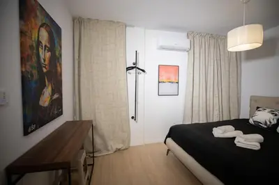 a bedroom with a bed with two towels on it at Vivid Stays Chalkokondili in Nicosia