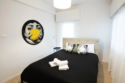 a bedroom with a large bed with a black blanket at Vivid Stays Chalkokondili in Nicosia