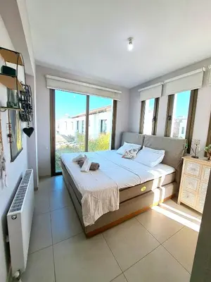 a bedroom with a large bed and a large window at Villa Allamare with a pool in Paralimni