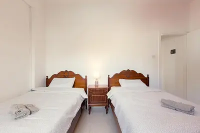 two beds sitting next to each other in a room at Spacious Larnaca Beach Apartment in Larnaka