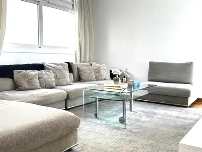 a living room with a couch and a glass table at Wealthystays Duplex in the Heart of Nicosia in Nicosia
