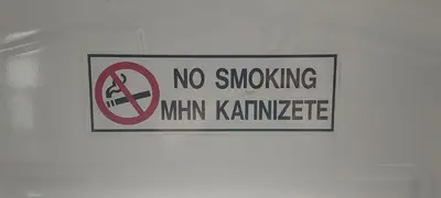 a no smoking sign on a white wall at Sea Breeze Maisonette in Larnaka
