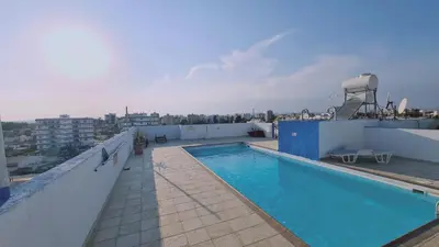 a swimming pool on the roof of a building at STAY Suncity Apartment in Larnaka