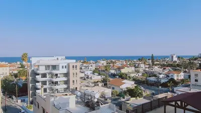 an aerial view of a city with buildings and the ocean at STAY Suncity Apartment in Larnaka