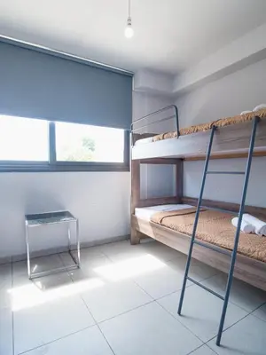 a room with two bunk beds and a table at Maestro Villa in Meneou