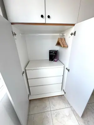 a walk in closet with white cabinets at Casa Sea Breeze in Larnaka