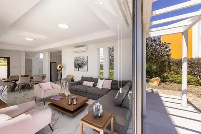 a living room with a couch and a table at Villa Milos 36 in Protaras