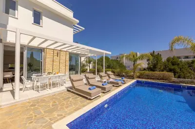 a villa with a swimming pool and a house at Villa Milos 36 in Protaras