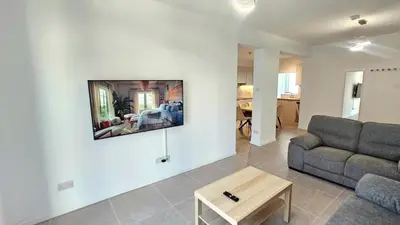 a living room with a couch and a table at Kanika 3 bedroom city beach in Limassol